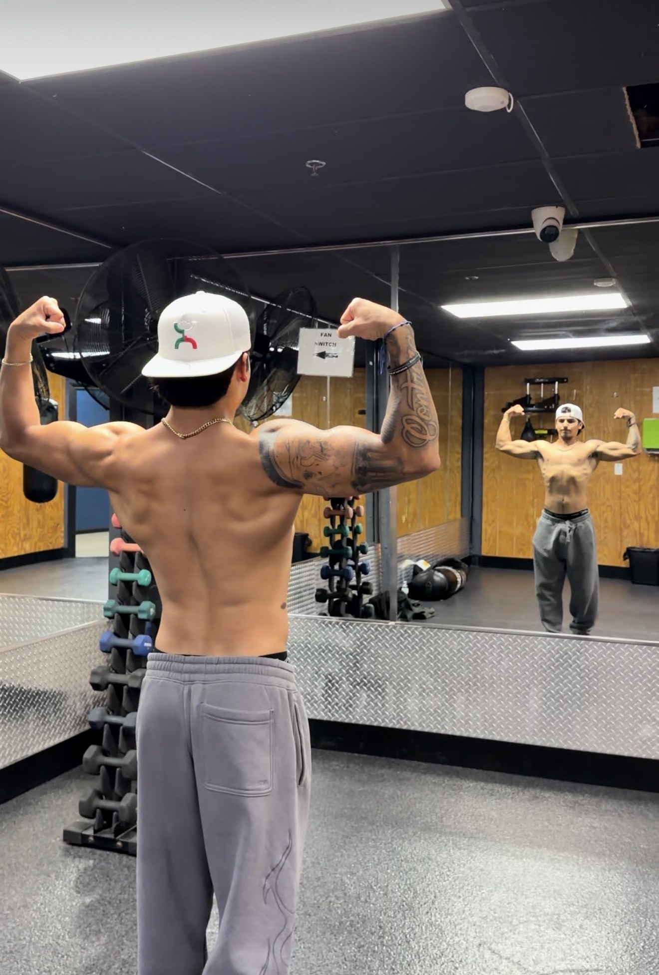 Andrew Contreras flexing after a back workout